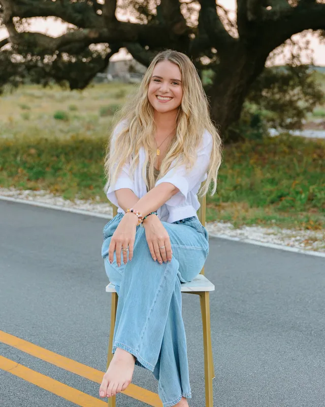 Ali, licensed therapist and founder of All Moments Counseling, smiling outdoors